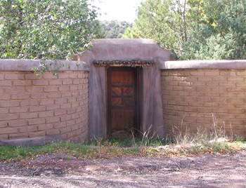 Exposed adobe garden wall in Tesque, New Mexico